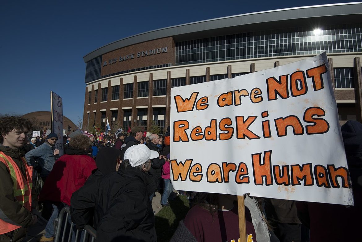 1200px-Protest_against_Washington_football_team_name_(15510343527) Let’s Stop “Playing Indian”
